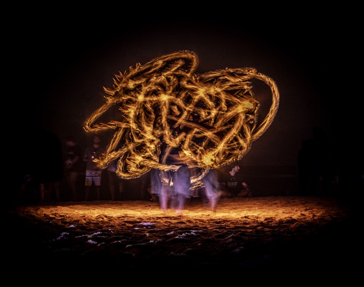 Light trails from a fire dancer spinning at night