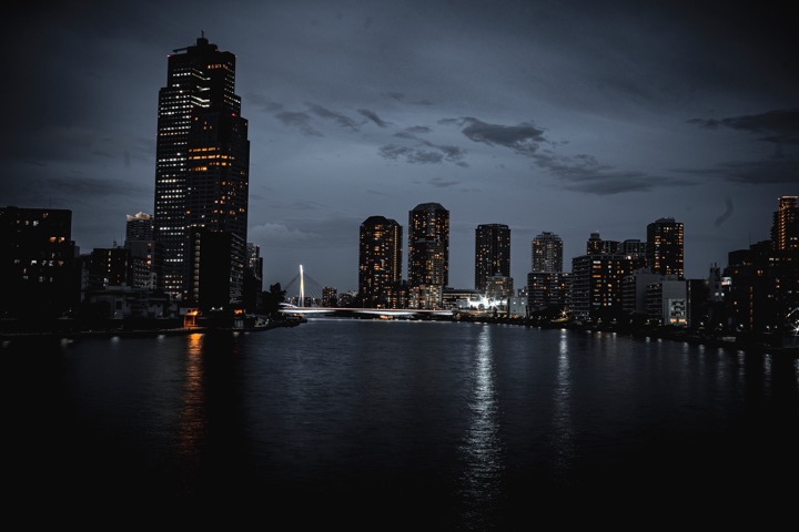 City skyline across a river at blue hour
