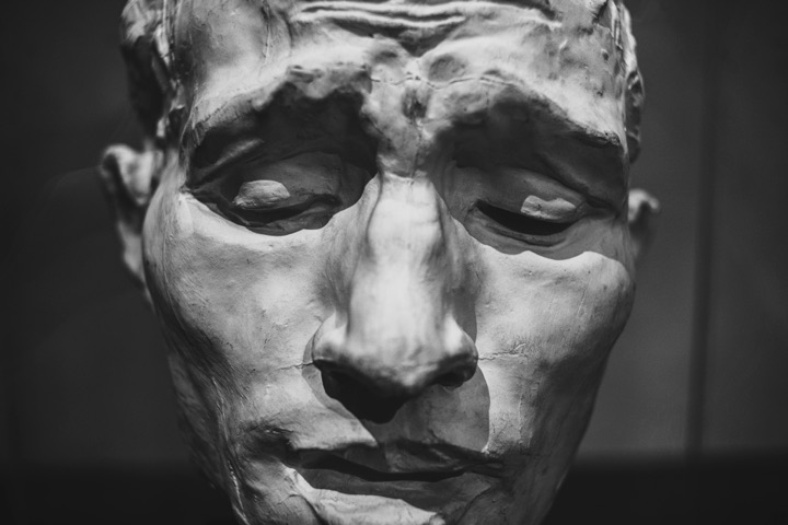 Close-up of a weathered stone sculpture of a face